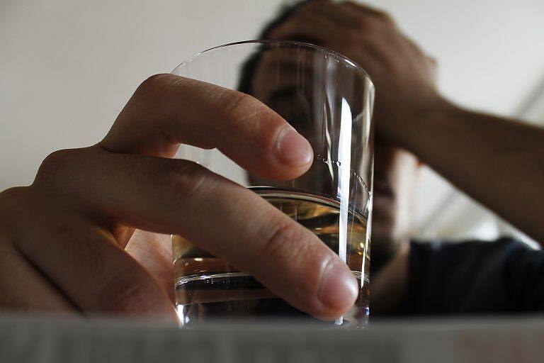 Close-up of a hand holding a glass of alcohol, with a blurred figure in the background, illustrating alcohol addiction|Public Health England infographic detailing alcohol harms to the body, including 60 medical conditions caused by alcohol such as cancer, liver disease, and depression, with visual icons representing health impacts|Informational graphic with brain icon stating: An ALCOHOL DISORDER encompasses a range of behaviours, and can be mild, moderate or severe|Pink logo with rounded rectangle border containing the text "THE RECOVERY TOOLKIT" in bold capital letters, symbolizing a comprehensive approach to addiction recovery|Symbolic image of alcohol addiction: a glass of whiskey connected by handcuffs to a person's wrist, representing the struggle and need for intervention in alcohol abuse|Infographic showing a bottle-shaped graphic listing 60 medical conditions caused by alcohol, including cancers, liver disease, and depression, with icons representing various health impacts|Man in white shirt slumped over table with alcohol bottle and glass, chained to bottle, symbolizing alcohol addiction and the need for intervention|Infographic from Public Health England showing alcohol harms to the body, including 60 medical conditions such as cancer, liver disease, and depression|Pyramid diagram showing the spectrum of alcohol use, ranging from abstinence at the bottom to alcohol use disorders and unhealthy alcohol use at the top|Wooden signpost showing 'Recovery' pointing upwards, with other signs pointing to 'Pain', 'Sorrow', 'Drugs', 'Alcohol', and 'Addiction' against a serene natural background