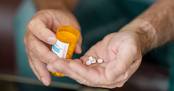 Hands holding a prescription pill bottle and several white tablets, illustrating medication management for Bromazepam addiction treatment|Elderly hands holding an orange prescription bottle and several white pills, illustrating potential medication misuse among older adults|Glass of whiskey with ice cubes next to an open pill bottle with scattered white pills on a wooden surface, illustrating the hazardous combination of alcohol and medication|Diverse group of people sitting in a circle on folding chairs in a lush garden setting, engaged in an outdoor therapy session led by a professional in a white coat|Infographic on Bromazepam addiction showing 40% of regular users become addicted, 2 weeks to become dependent, 509 benzodiazepine deaths in UK 2022, and worse withdrawal than most benzodiazepines, with Detox Plus contact information|Infographic showing Bromazepam addiction facts: 40% of regular users become addicted, 2 weeks to become dependent, 509 benzodiazepine deaths in UK 2022, and worse withdrawal than most benzodiazepines|Glass of whiskey on ice next to an open pill bottle with scattered white tablets, illustrating the hazardous combination of benzodiazepines and alcohol|Medication box of Lexotanil, containing 3mg Bromazepam tablets, a prescription benzodiazepine associated with addiction risk|Outdoor group therapy session with diverse participants sitting in a circle, led by a therapist in a white coat, illustrating a supportive environment for addiction treatment