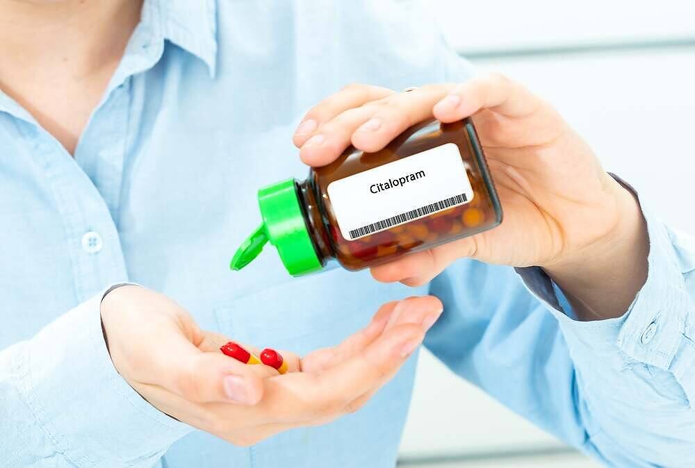 Healthcare professional dispensing citalopram pills from prescription bottle for depression treatment|Diagram explaining SSRI (Selective Serotonin Reuptake Inhibitors) on a chalkboard, showing its components: Selective, Serotonin, Reuptake, and Inhibitor