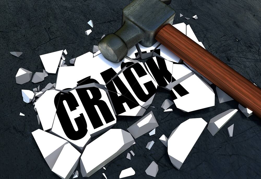 3D illustration of a hammer shattering the word "CRACK" on a dark background, symbolizing the process of overcoming crack cocaine addiction|Close-up of crack cocaine rocks and drug paraphernalia on a dark surface, illustrating the dangers of crack cocaine addiction and the need for rehabilitation