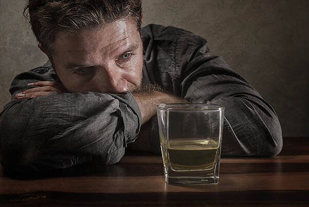 Depressed man staring at a glass of alcohol, illustrating the challenges of giving up drinking|Infographic detailing professional alcohol detox, including common medications like Naltrexone, Disulfiram, and Benzodiazepines, and showing improved success rates of 20% to 50% with medicated detox|Comprehensive infographic detailing the duration and symptoms of alcohol withdrawal, including short-term effects like anxiety and insomnia, long-term effects like PAWS, and serious withdrawal symptoms such as seizures and hyperthermia|Infographic showing common symptoms during alcohol withdrawal over 8 days, including hangover, night sweats, shaking, paranoia, relief, brain fog, cravings, and improved sleep|Infographic detailing alcohol withdrawal symptoms over time, including acute symptoms like anxiety and tremors, Week 2 symptoms like depression and brain fog, long-term PAWS symptoms, and serious withdrawal symptoms affecting 10% of people|Depressed man staring at a glass of alcohol, illustrating the challenges of giving up drinking