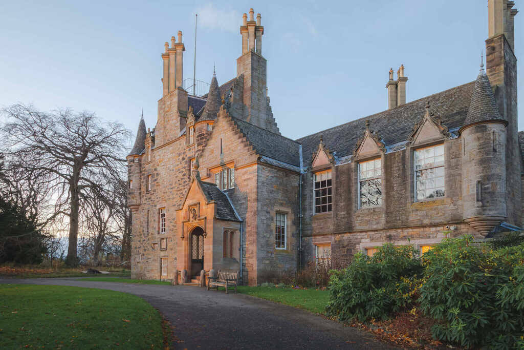 Historic Scottish manor house with stone facade and turrets, serving as a luxurious rehab facility in Glasgow|Female counselor leading a group therapy session with four participants in a bright, supportive environment|Young male doctor in white coat reviewing medical documents with elderly male patient during consultation|Side-by-side MRI brain scans comparing a normal 43-year-old brain to an alcoholic 43-year-old brain, showing visible differences in brain structure|Infographic showing various aspects of mindfulness including meditation, breathing, balance, stress reduction, awareness, body, and soul, with icons representing each concept|Spacious, sunlit bedroom with wooden floors, blue walls, and balcony view, showcasing comfortable accommodations for alcohol rehab in Glasgow
