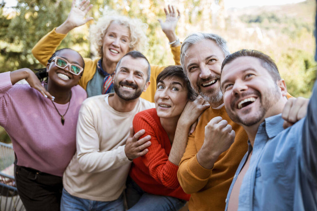 Diverse group of smiling people in colorful clothing embracing and celebrating, representing support and community in addiction recovery|Four adults engaged in a supportive group therapy session, smiling and interacting positively, demonstrating the benefits of community support in addiction recovery|Infographic showing the progression of alcohol-induced liver damage from fatty liver to cirrhosis, with human silhouette and liver illustrations depicting each stage and corresponding health impacts|Iconic London skyline at dusk with text overlay "Alcohol Detox in London"|Hands opening wooden doors revealing a bright, sunny field with blue sky and the text "Time to Detox" overlaid, symbolizing hope and new beginnings in addiction treatment|Back view of a bald man in a leather jacket facing the London skyline with the Gherkin building prominent, overlaid with text "Time to Detox"|Rear view of a bald man in a leather jacket facing the London skyline with the Gherkin building prominent, text overlay reads "Time to Detox", symbolizing urban professional seeking addiction treatment|Large brick house with well-maintained garden, offering a comfortable and private setting for alcohol detox and rehabilitation in London|Cozy attic bedroom in a London alcohol detox facility, featuring wooden walls, plush bedding, and modern amenities for a comfortable recovery experience