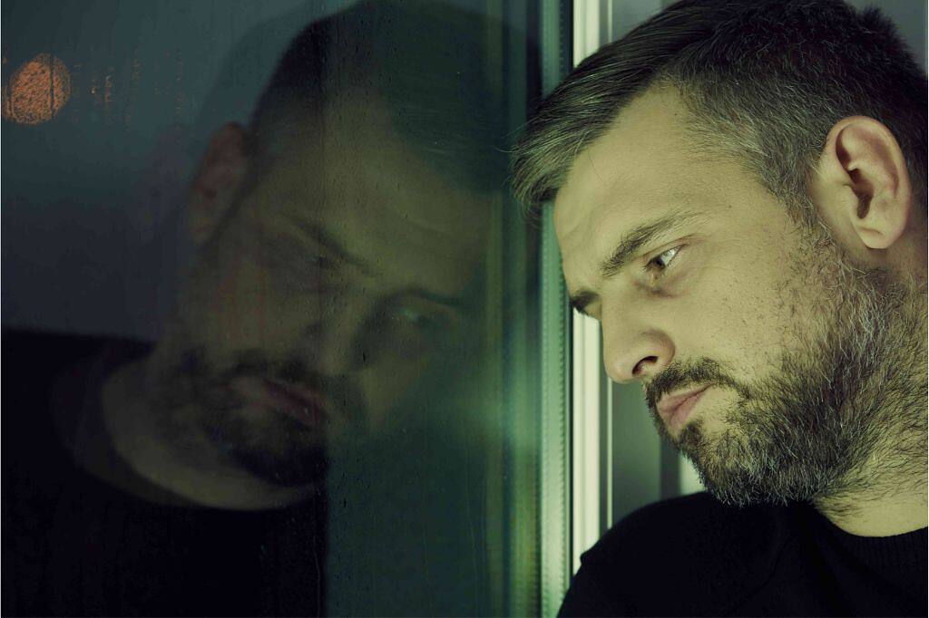 A man looking contemplative, leaning against a window, symbolizing introspection during addiction recovery.|Close-up of a clock face with the words "Time to Sober Up" instead of numbers, emphasizing the importance of taking action for sobriety
